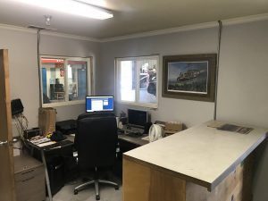 A desk with computer table and chair