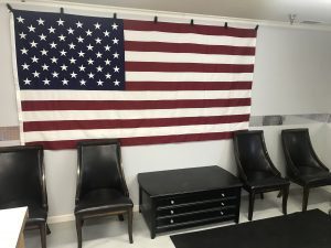 An american flag on the wall of a office