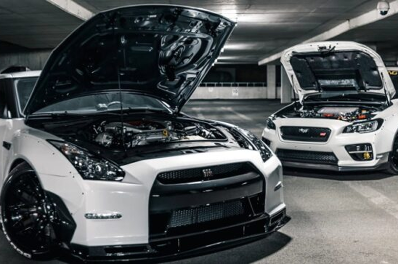 Sports cars parked with hoods open