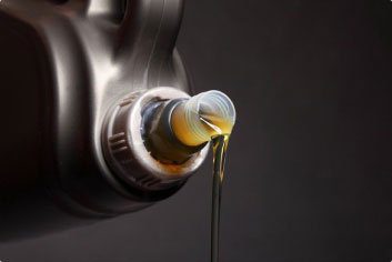 Pouring motor oil from container