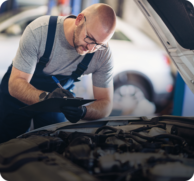 Mechanic inspecting car engine