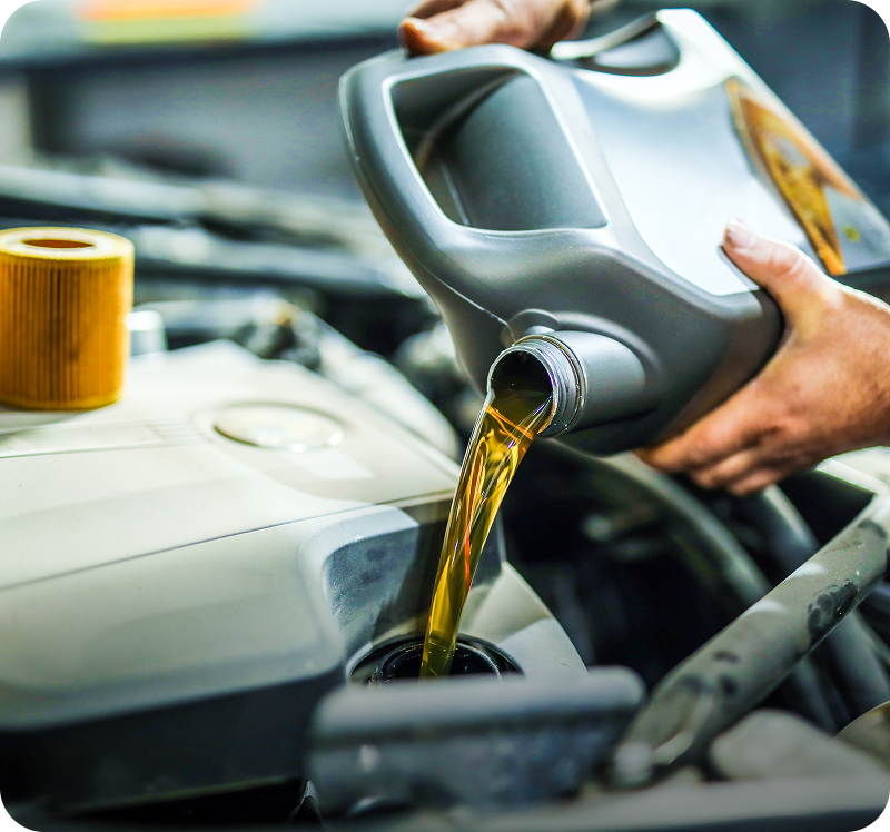 Pouring engine oil into car